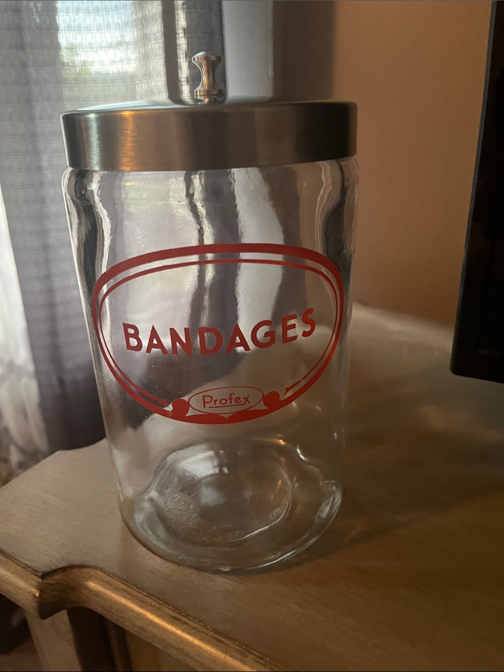 Clear Glass Bandage Jar with Red Accent and Silver Lid